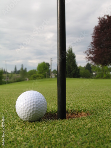 golf ball beside the hole
