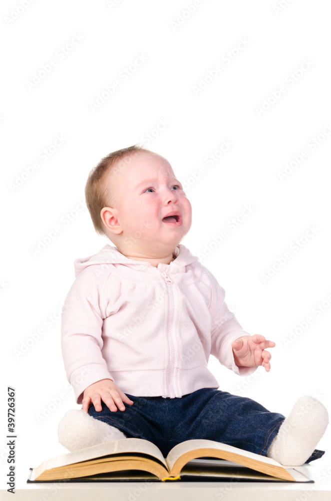 little baby is crying with a book little baby is crying with a book