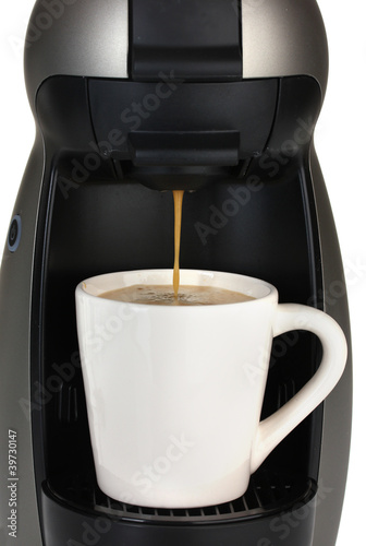 Espresso machine pouring coffee in white cup