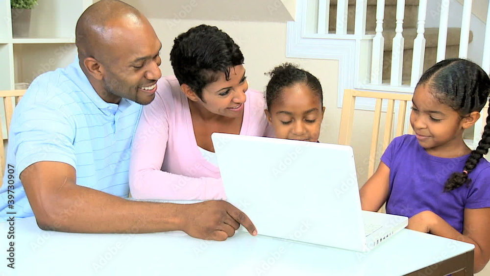 Ethnic Parents Watching Daughters Using Laptop Ethnic Parents Watching Daughters Using Laptop