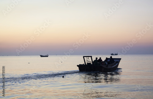 Fishermen go out to work. Morning on the Yellow Sea, China, Qinh
