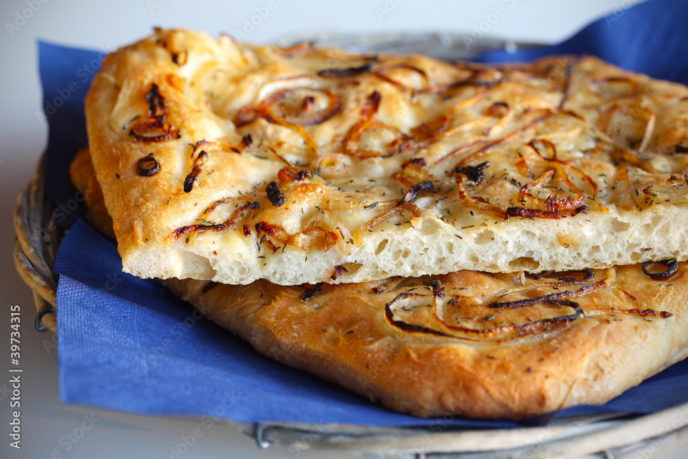 Focaccia bread with onions and thyme in a twiggy basket Focaccia bread with onions and thyme in a twiggy basket