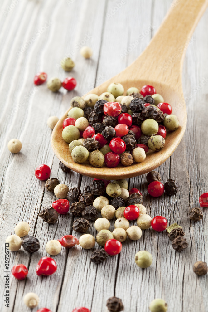 Colored Peppers Mix and wooden spoon Colored Peppers Mix and wooden spoon