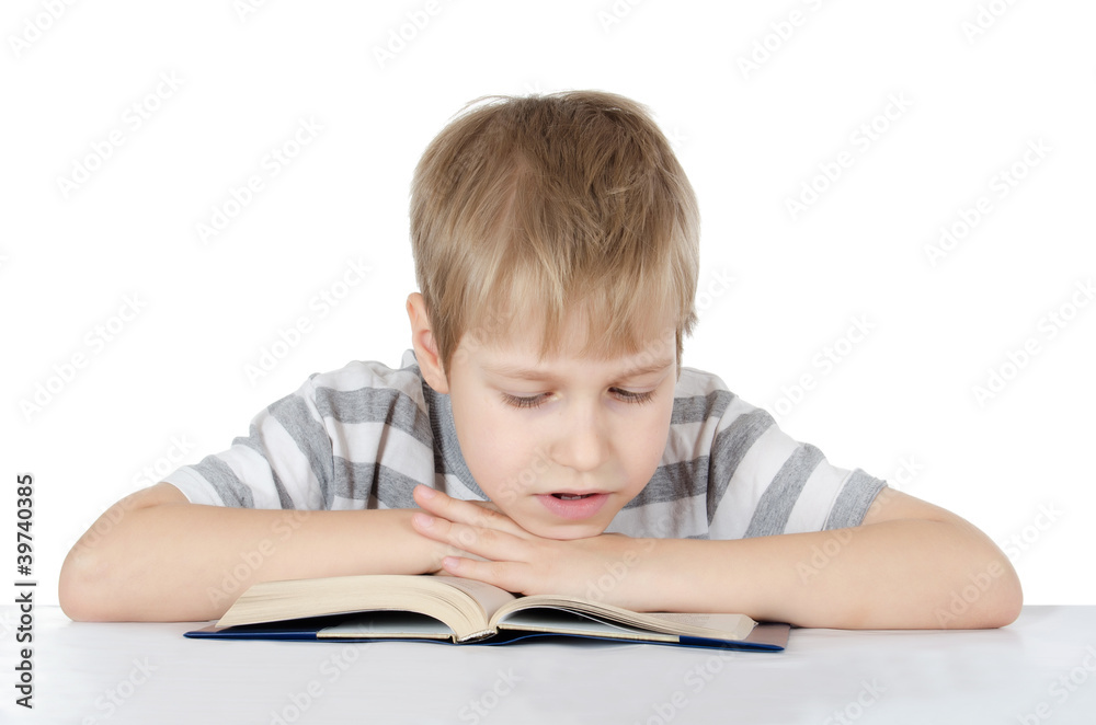 The boy reads the book isolated on white The boy reads the book isolated on white
