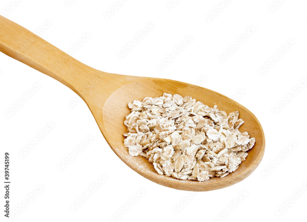 Rolled oats in spoon on white Rolled oats in spoon on white