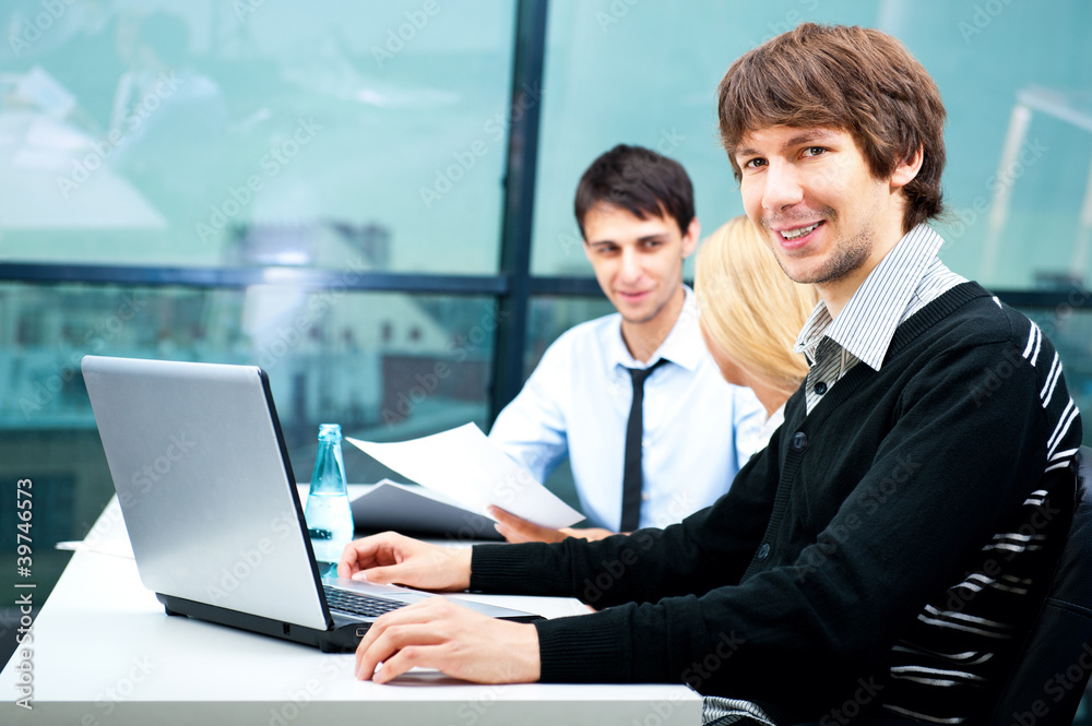 Fototapeta premium Three contemporary business people at a meeting