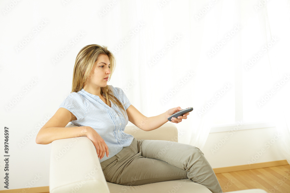 Woman using a control remote Woman using a control remote