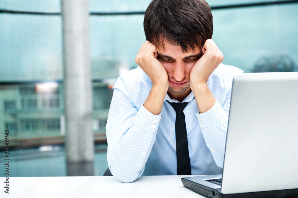 Tired businessman sleeping at his desk in the office Tired businessman sleeping at his desk in the office