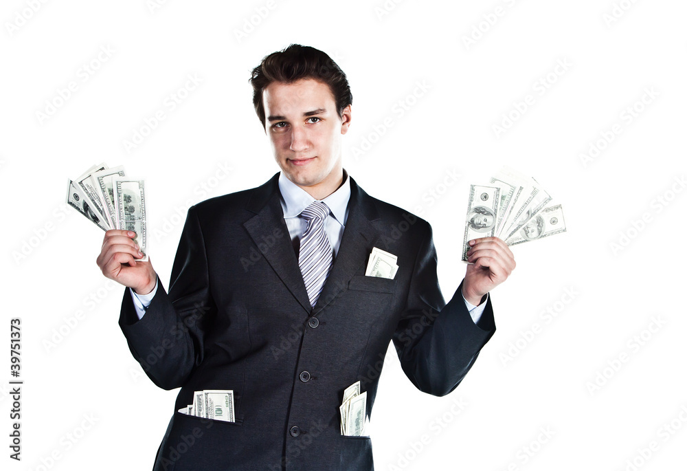 young businessman in a dark suit surrounded by flying dollars young businessman in a dark suit surrounded by flying dollars