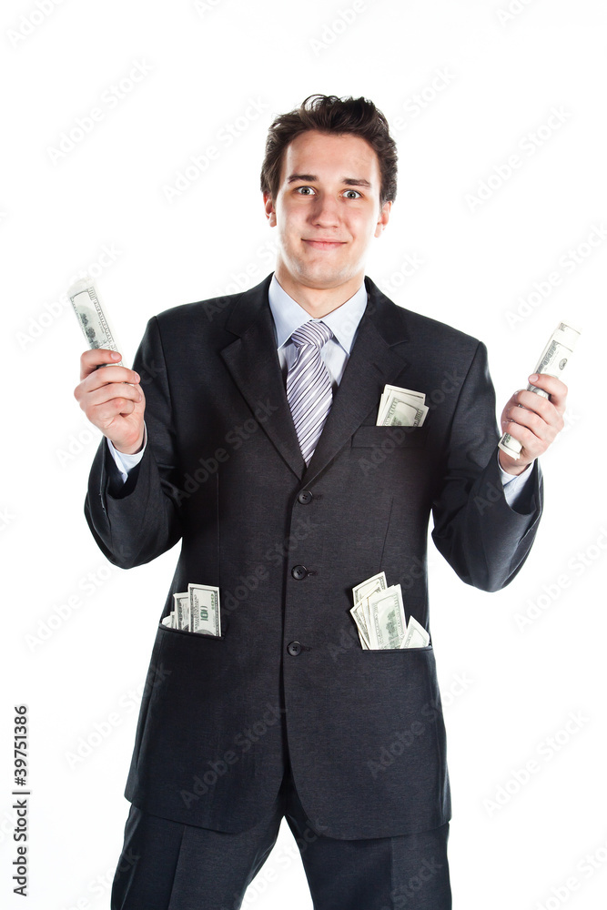 young businessman in a dark suit surrounded by flying dollars young businessman in a dark suit surrounded by flying dollars