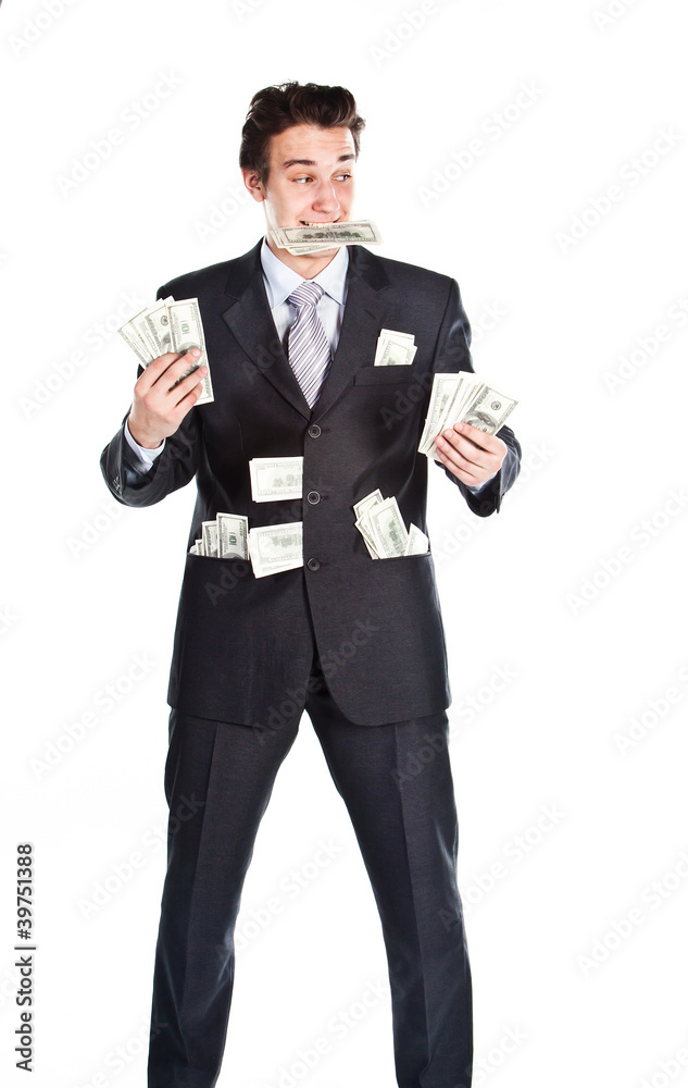young businessman in a dark suit surrounded by flying dollars young businessman in a dark suit surrounded by flying dollars