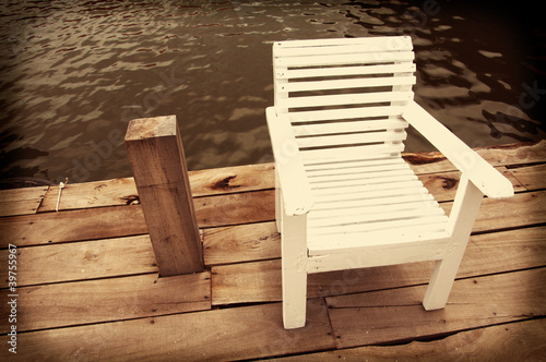 wood chair against water pool