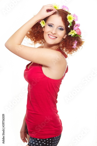 smiling ginger woman in red cloth with colorful flowers in hair