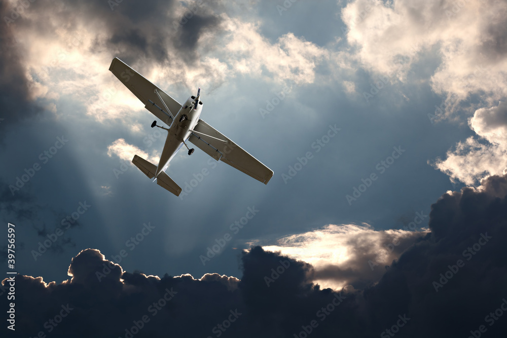 Small fixed wing plane against a stormy sky - obrazy, fototapety, plakaty 