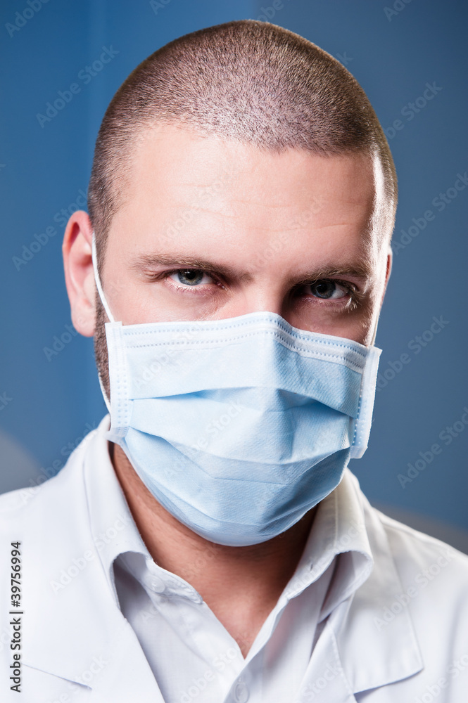 Portrait of a serious confident doctor in mask. Concept of coronavirus or covid-19, corona virus or covid19 Portrait of a serious confident doctor in mask. Concept of coronavirus or covid-19, corona virus or covid19