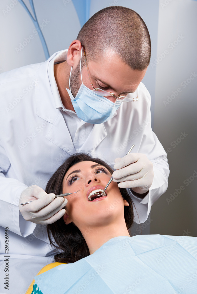 Female patient having her teeth examined by specialist Female patient having her teeth examined by specialist