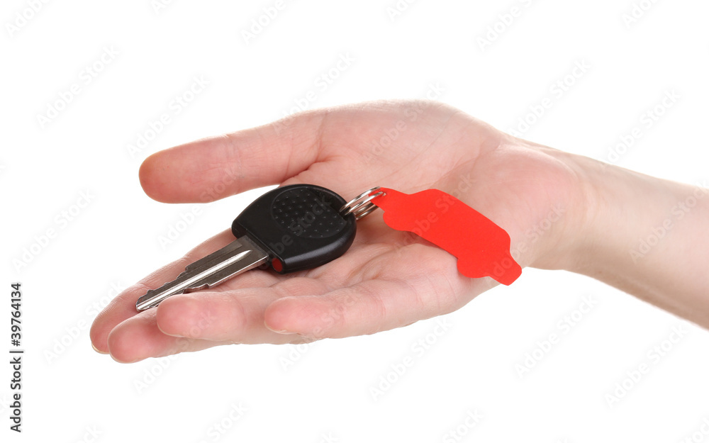 Car key with charm in hand isolated on white Car key with charm in hand isolated on white