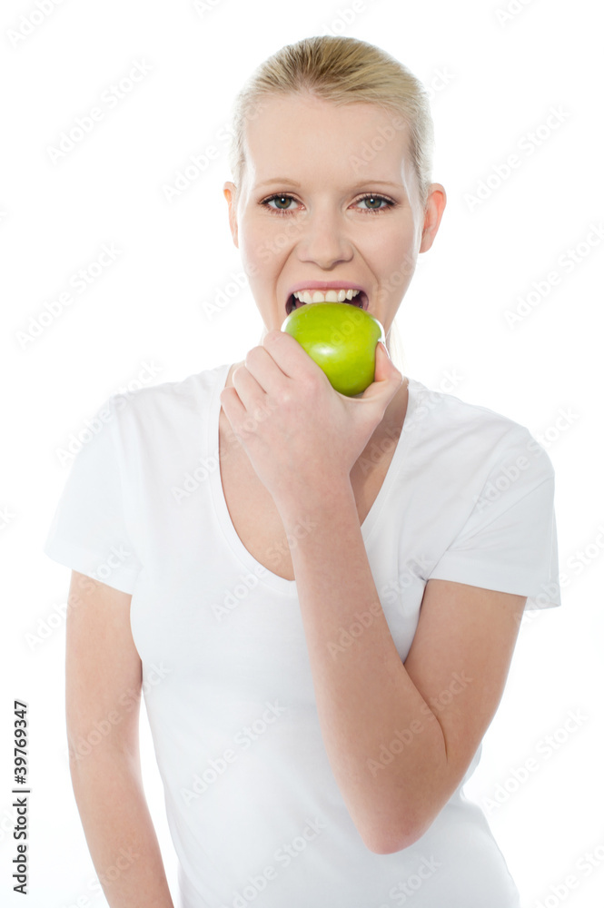 Healthy young girl eating nutritious green apple Healthy young girl eating nutritious green apple