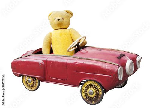 Photos Old teddy bear in a vintage toy car