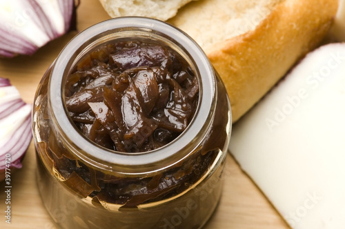 Onion jam in jar, goat's cheese and fresh bread
