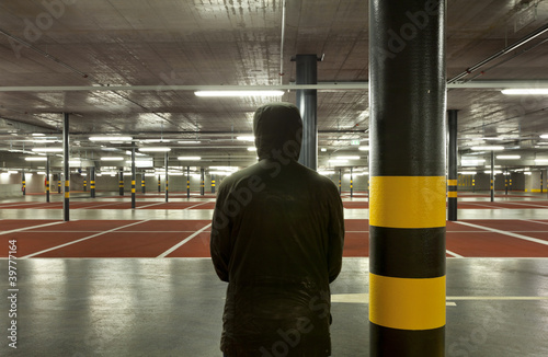 Φωτογραφία new underground parking, back view of shady man.