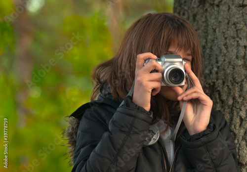 Teenage girl taking pictures with point and shoot camera