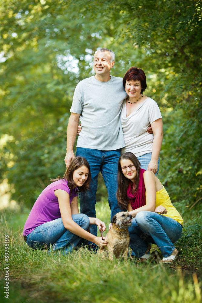 Family portrait - Family of four with a cute dog outdoors