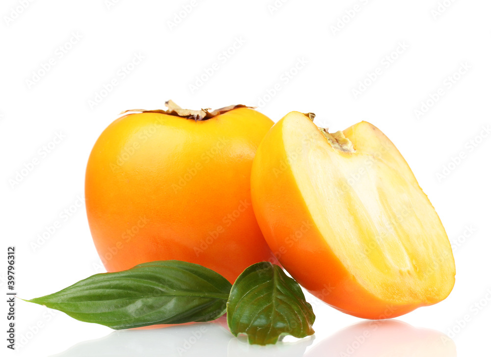 One and half appetizing persimmon with green leaves isolated One and half appetizing persimmon with green leaves isolated