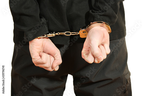 Bandit in black mask handcuffed isolated on white