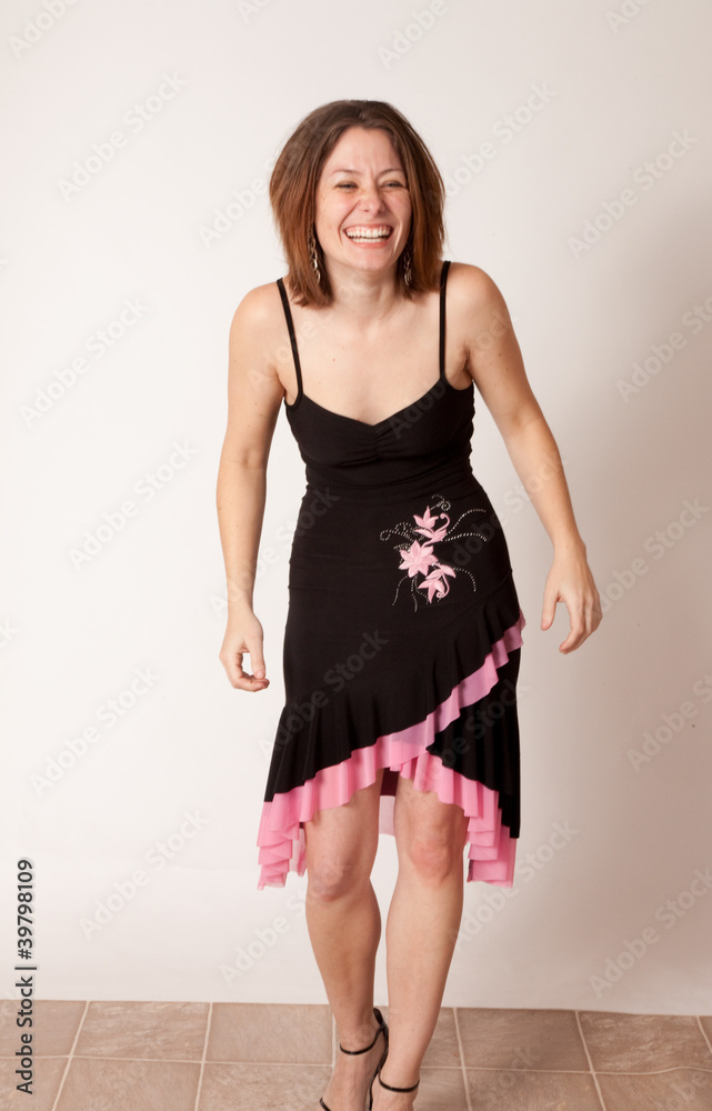 woman in black dress smiling at the camera