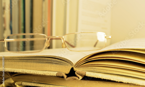 glasses lying on the open book photo