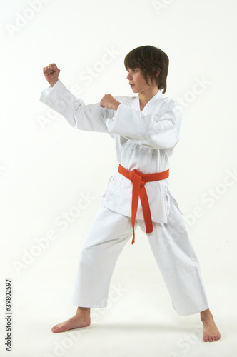 boy practicing karate on white background