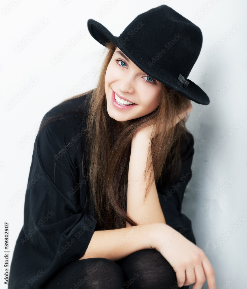 Beautiful portrait of smiling stylish young woman in black hat Beautiful portrait of smiling stylish young woman in black hat