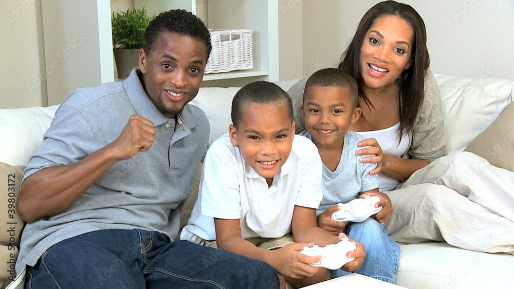 Ethnic Family Playing Handheld Electronic Gamea Ethnic Family Playing Handheld Electronic Gamea