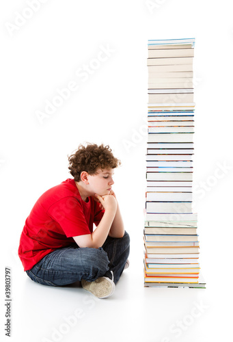 Student sitting close to pile of books on white background