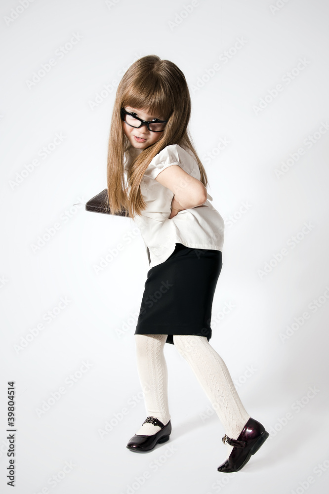 Little girl waering glasses with notebook in her right hand Little girl waering glasses with notebook in her right hand