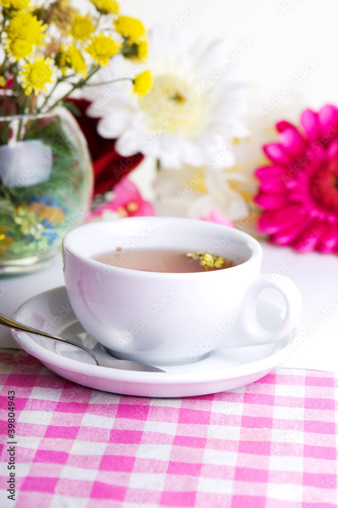 Cup of tea with flower on table Cup of tea with flower on table
