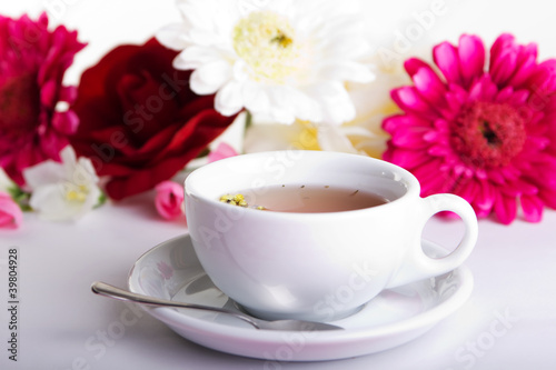 Cup of tea with flower on table