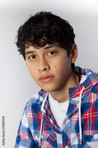 Handsome young Hispanic man in plaid shirt