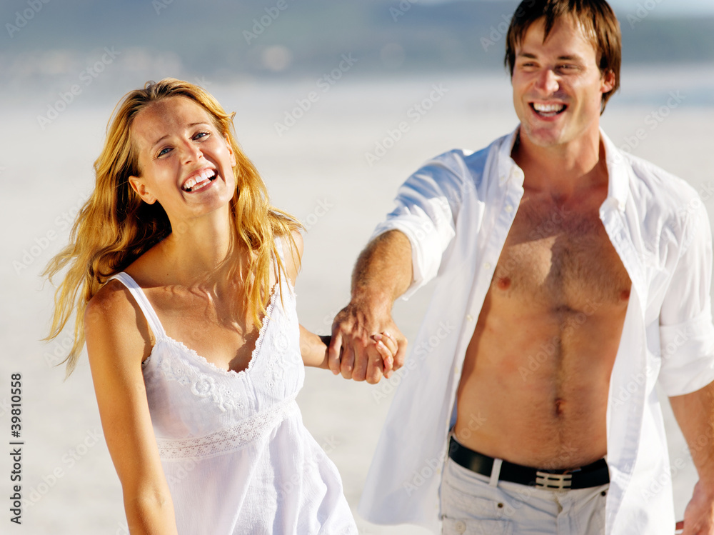Fototapeta premium carefree walking beach couple