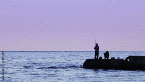 Two fishermen caught fish from the pier