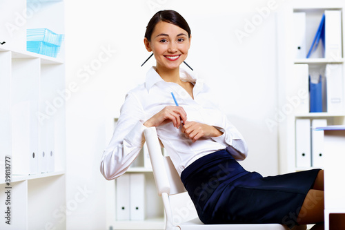 Young woman in business wear in office