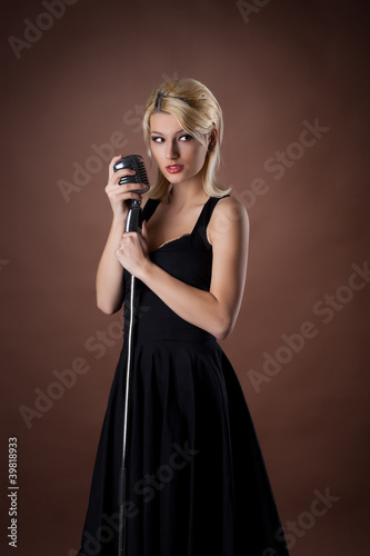 woman pin-up portrait in black with microphone