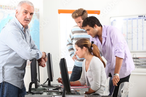 Manager and his team working at computers photo