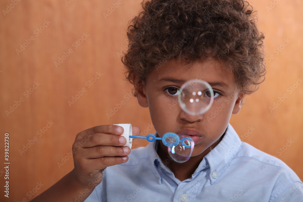 Little boy blowing bubbles