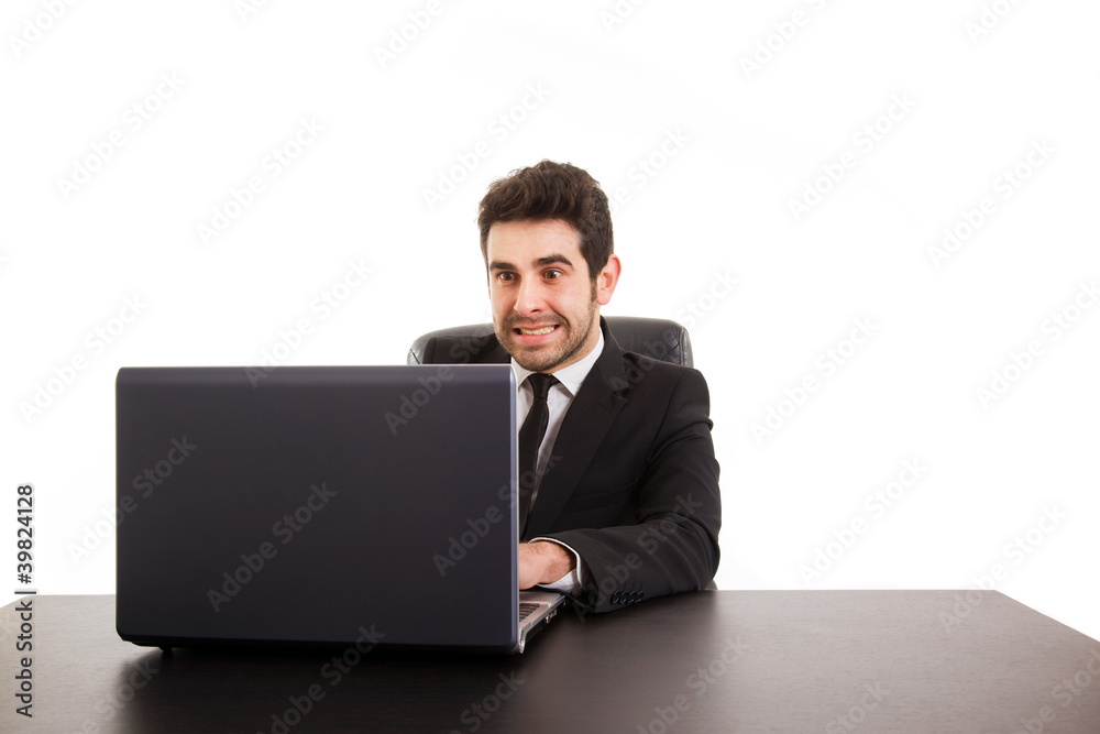 Young business man with laptop at office desk, isolated in white Young business man with laptop at office desk, isolated in white