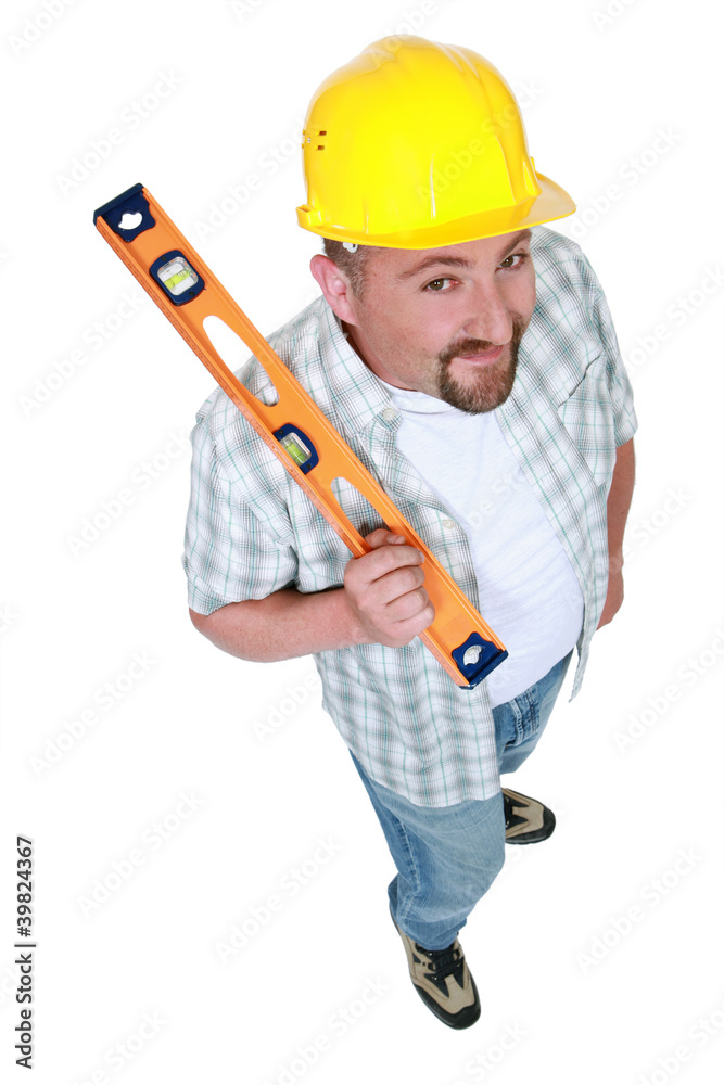 Tradesman holding a spirit level Tradesman holding a spirit level