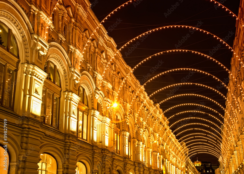 Holiday illumination in  form of an arch on an ancient building