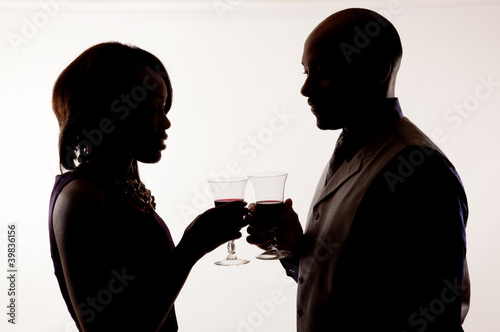 Silhouette of couple drinking wine together