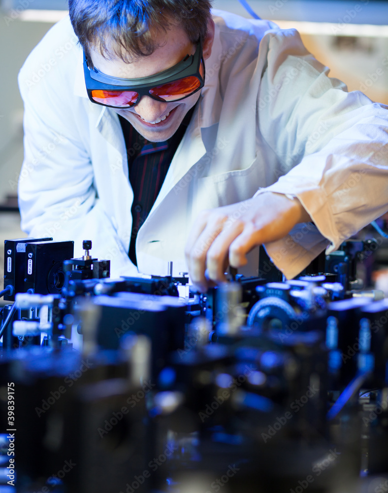scientist doing research in a quantum optics lab (shallow DOF; scientist doing research in a quantum optics lab (shallow DOF;
